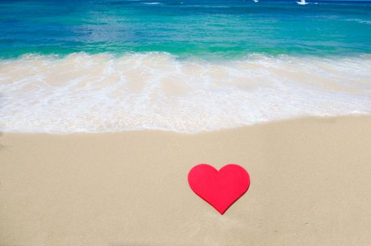 Heart shape on sandy beach by the ocean