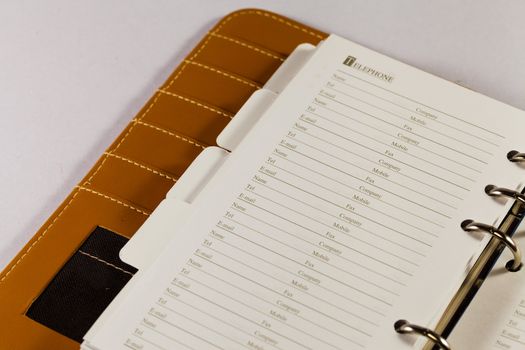 Close up image of black note book organizer against white background