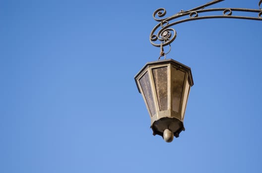 retro iron light lamp lantern on background of dark blue sky.