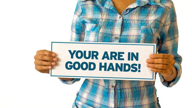 A woman holding a You are in Good hands sign.