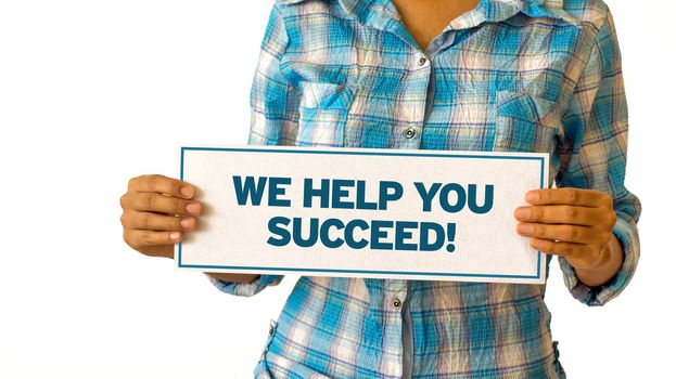 A woman holding a We Help You Succeed sign.