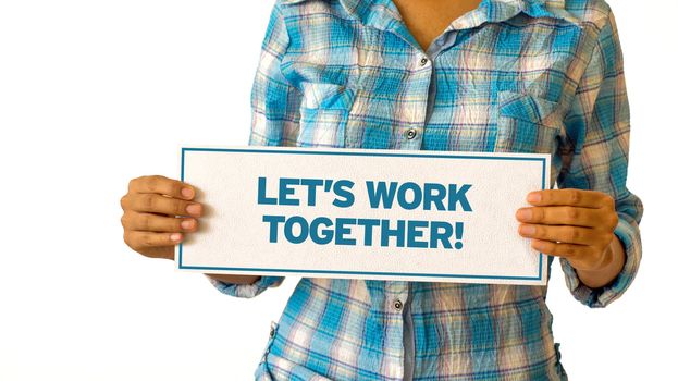 A woman holding a Lets Work Together sign.
