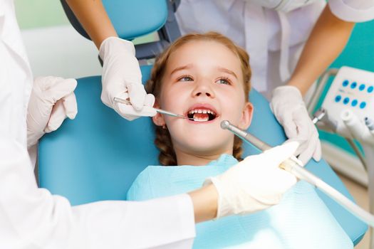 Little girl sitting in the dentists office