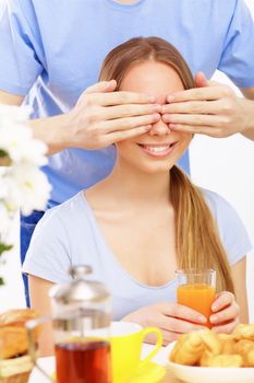 Young couple at home together - closing partner's eyes