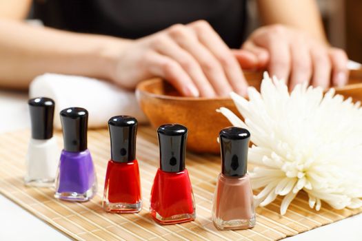 Young woman is getting manicure in a beauty salon