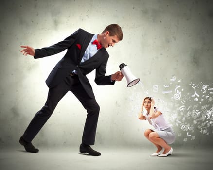 Angry businessman with megaphone shouting at colleague