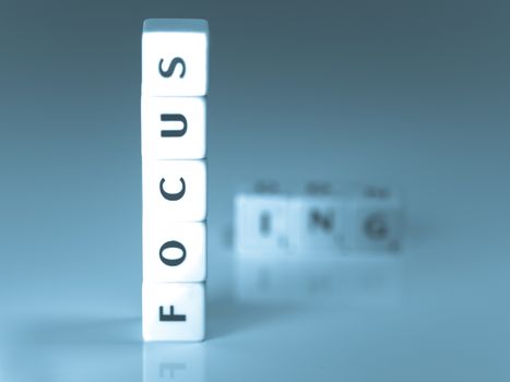 Focus word made of scrabble pieces with reflection for business concept
