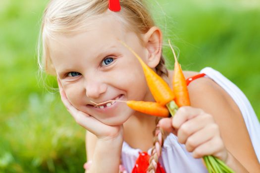 small girl with carrots