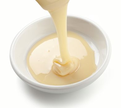 Condensed milk is flowing in the white plate