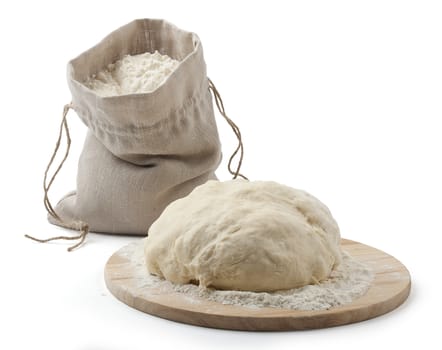 A flour in the sack and a pastry on the wooden board