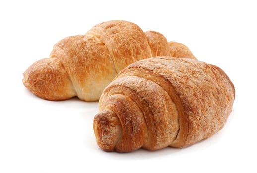 Two fresh croissant on the white background