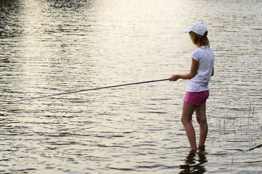 Girl fishing in a lake