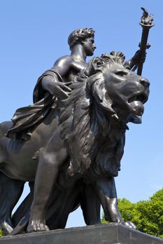 One of the bronze statues that surround the Victoria Memorial outside Buckingham Palace in London.