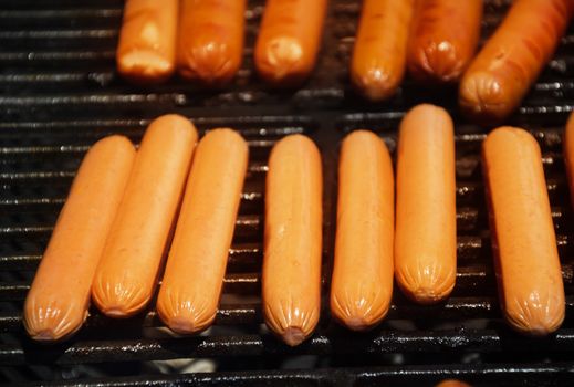 Sausages preparing on grill in summer day