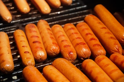 Sausages preparing on grill in summer day