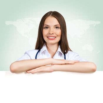 Young attractive female doctor put her hands on the blank banner, place for text