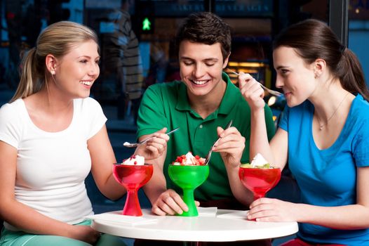 Three friends enjoying day out in a restaurant.