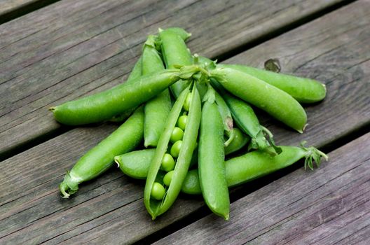 Fresh peas on a background of old boards