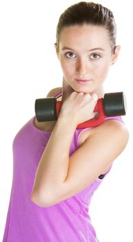 Serious young woman with dumbbell near her face