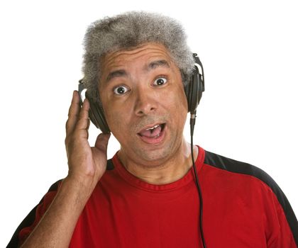 Excited middle aged man holding pair of headphones