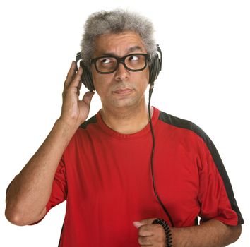 Handsome mature man listening with headphones on white background