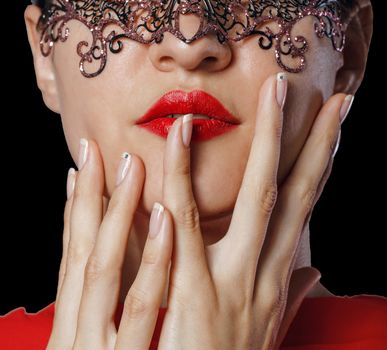 Girl in a Venetian masquerade mask isolated on a black background