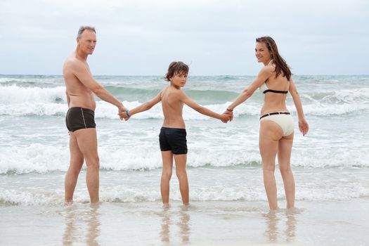 happy family ith two boys having fun in water summer holiday vacation