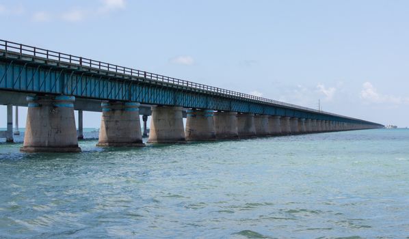 The Seven Mile bridge was built by Henry Flagler as part of the Overseas Railroad to Key West. After a hurricane shut down the railroad, Florida purchased this bridge and used it as part of the overseas highway to Key West. Today this 2.2 mile section is used for pedestrians, fishermen, and bicyclists and connects to Pigeon Key. The new seven mile bridge can be seen running alongside the old bridge.