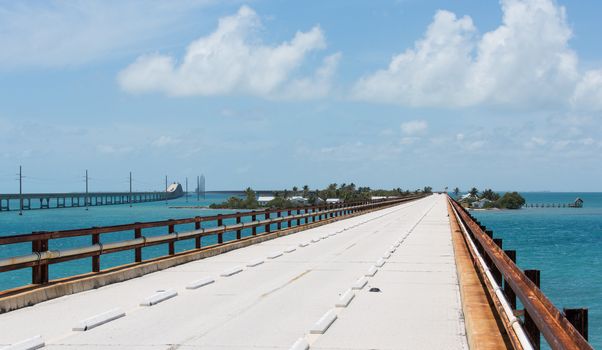 Pigeon Key with the old Seven Mile Bridge going through it. The new bridge bypasses it. The handrails seen on the old bridge are the orginal railroad tracks used on the Overseas Railroad.