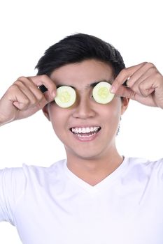 Man with cucumber slices on eyes, isolated on white