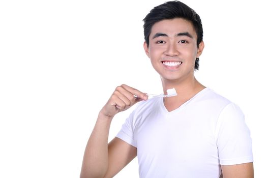 Asian guy brushing teeth, isolated on white