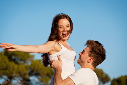 attractive young couple in love summertime on beach smiling romance