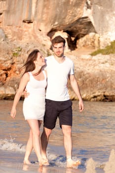 happy young couple on the beach in summer holiday love togetherness