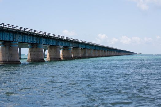 The Seven Mile bridge was built by Henry Flagler as part of the Overseas Railroad to Key West. After a hurricane shut down the railroad, Florida purchased this bridge and used it as part of the overseas highway to Key West. Today this 2.2 mile section is used for pedestrians, fishermen, and bicyclists and connects to Pigeon Key. The new seven mile bridge can be seen running alongside the old bridge.