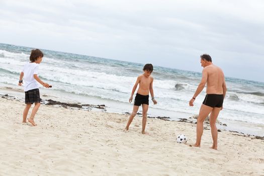 happy family father two kids playing football on beach summer fun soccer