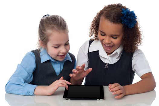 School girls playing on touch pad