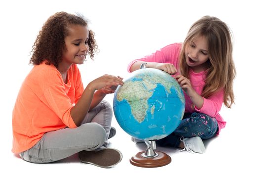 Elementary school girls playing with a globe