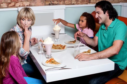 Family of four having great time in a restaurant