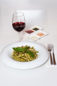 Delicious pasta served with sauces and red wine