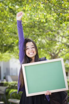 Portrait of An Attractive Excited Mixed Race Female Student Holding Blank Chalkboard and Carrying Backpack on School Campus.