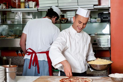 Male chefs working in kitchen, back-office shot