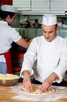 Two young chefs at work. Behind the scenes.