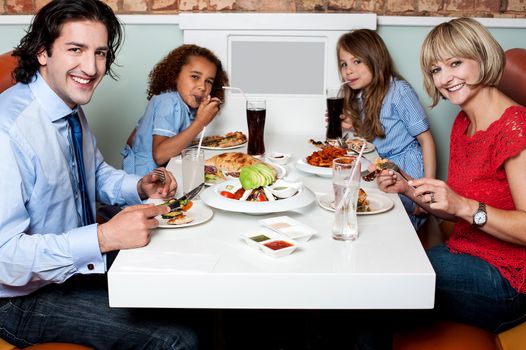 Family enjoying their dinner at a restaurant