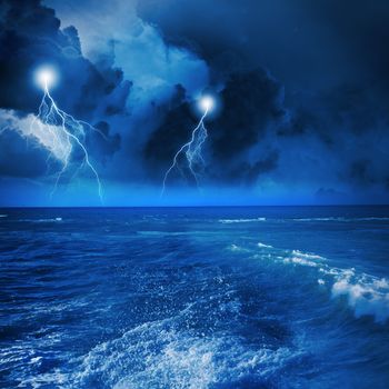 Image of night stormy sea with big waves and lightning