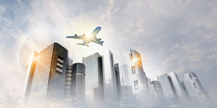 Plane flying above skyscrapers. Business travel concept