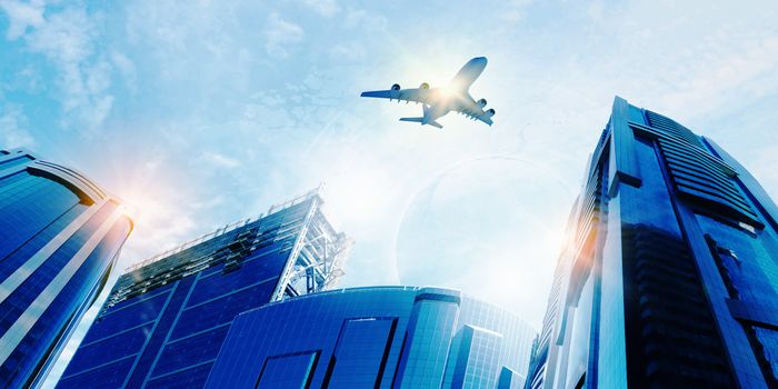 Plane flying above skyscrapers. Business travel concept