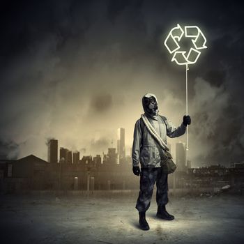 Man in respirator against nuclear background. Recycle concept