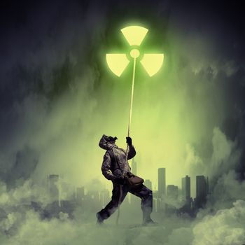 Man in respirator against nuclear background. Radioactivity concept