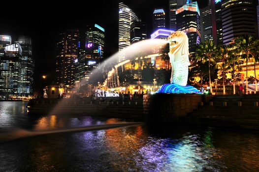 SINGAPORE - MARCH 07: The Merlion fountain spouts water in front of Singapore downtown on March 07, 2013 in Singapore. Merlion is an imaginary creature , often seen as a symbol of Singapore 
