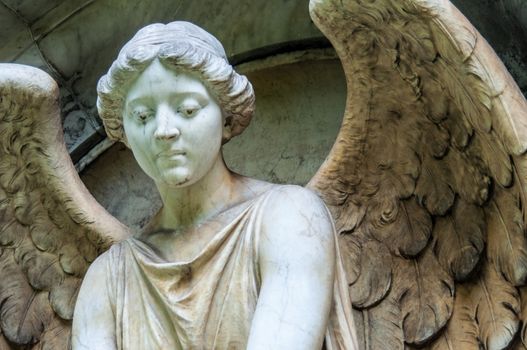 detail of a mourning sculpture on a cemetery